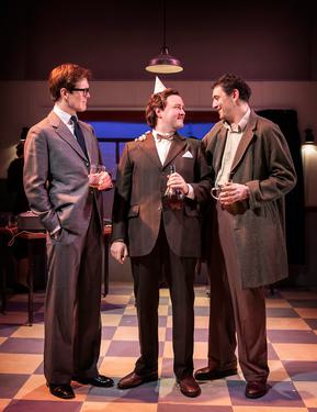 A production from from Spike. Three men in suits stand having a drink, and one of them has a party hat on